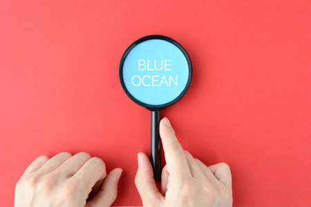 Businessman's hand to discover Blue Oceanの写真素材