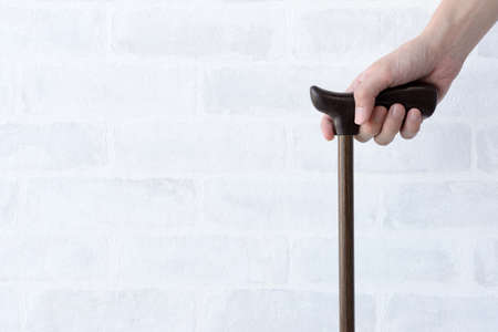 The hand of the person holding the caneの写真素材