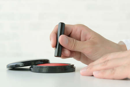 Seal, vermilion and people's handの写真素材