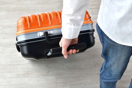 Leaving for a trip â the person pulling the carry caseの写真素材