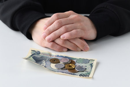 In the hands of a man with money worries