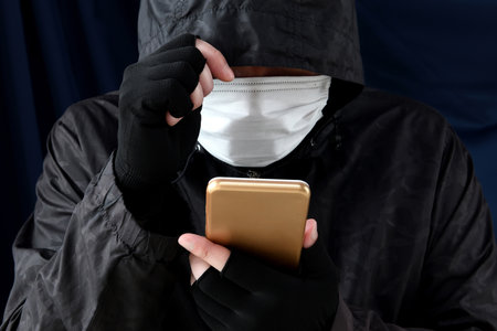 Image of a criminal handling a smartphone