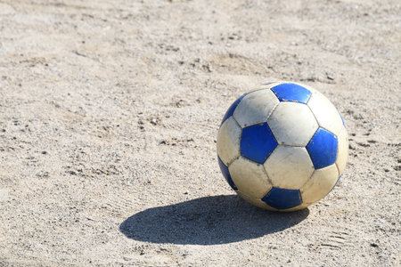 Soccer ball placed on uninhabited groundの写真素材
