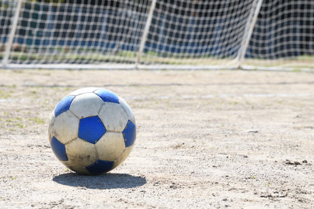 Soccer ball placed on uninhabited groundの写真素材