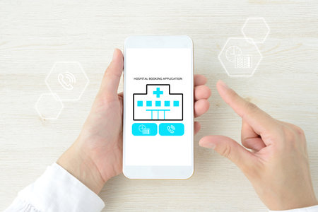 Image of a person using a hospital appointment appの写真素材