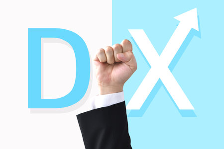 The letters DX and a businessman's raised fistの写真素材