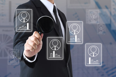 Image of analyzing various human resource characteristics with a magnifying glassの写真素材