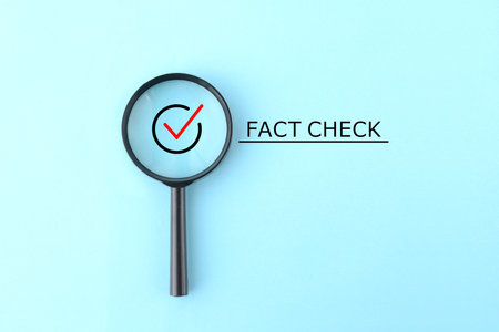 Check mark and fact check text in a magnifying glassの写真素材
