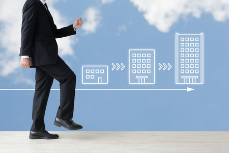 A businessman advancing his career to bigger and bigger companiesの写真素材