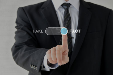 A man in a suit fact-checking and certifying factsの写真素材