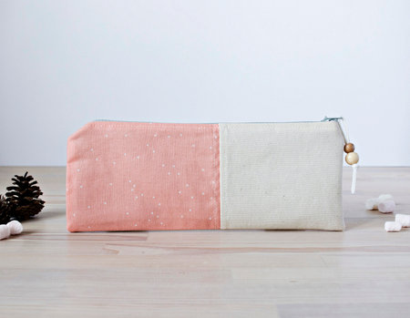 Handmade cotton pencil case with beads on the wooden tableの写真素材