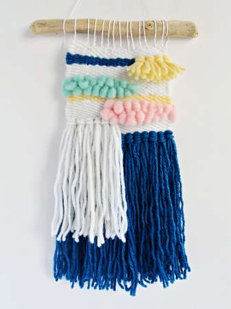 Colorful hand woven wall tapestry over whiteの写真素材
