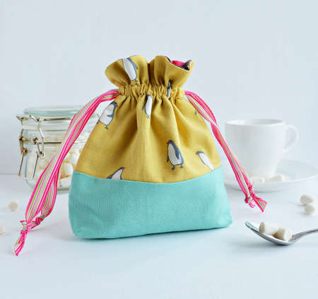 Colorful handmade drawstring bag with penguinsの写真素材