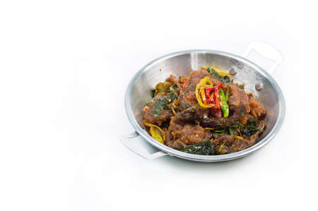 phad phed pla duk thod krob (stir fried deep fried catfish with curry paste), thai food. on white...