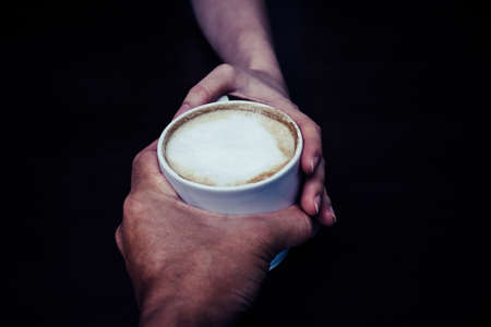 Men give coffee to a womanの写真素材