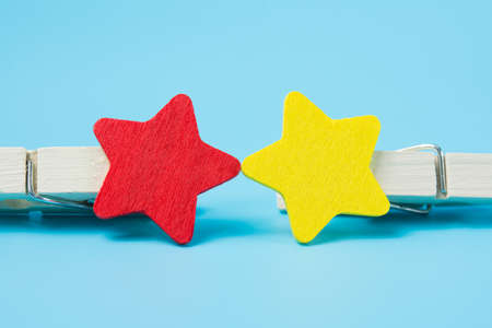 Set of wooden clothes pins on blue background.の写真素材