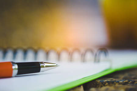 pen and notepad on table background
