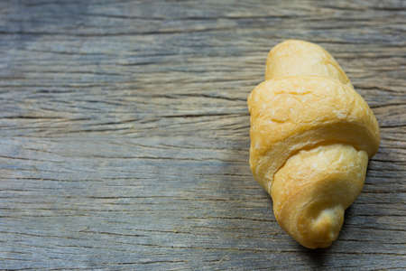 Tasty buttery croissants on old wooden table. rustic concept.の写真素材
