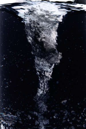 Underwater whirlwind on a black backgroundの写真素材