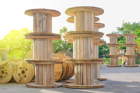 Wooden Coils Of Electric Cable Outdoor. High and low voltage cables in the storage.