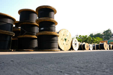Wooden Coils Of Electric Cable Outdoor. High and low voltage cables in the storage.の写真素材