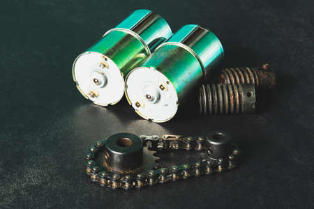 Motor, worm gear, drive sprockets and industrial driving roller chains. Vintage style photo.