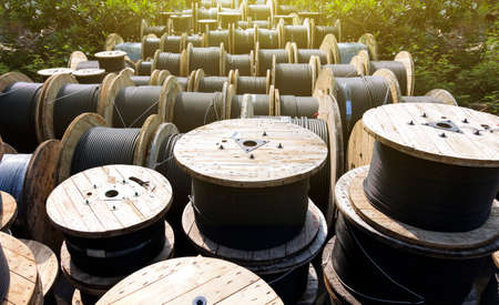 Wooden Coils Of Electric Cable Outdoor. High and low voltage cables in the storage.の写真素材