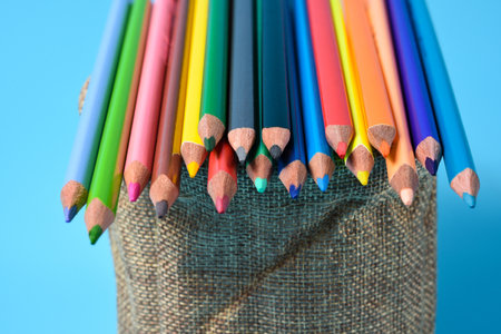 Colorful cryons on the table. Color pencils on blue background.の写真素材