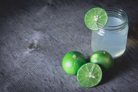 Fresh limeade on dark wooden table, Top view with copy space, life style