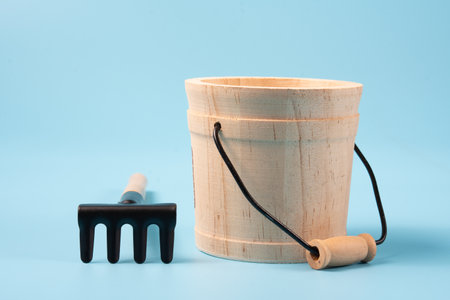 Garden tools made of iron with wooden elements on blue background.の写真素材