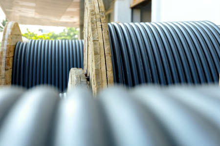 Wooden Coils Of Electric Cable Outdoor. High and low voltage cables in the storage.の写真素材