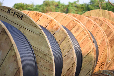 Wooden Coils Of Electric Cable Outdoor. High and low voltage cables in the storage.の写真素材