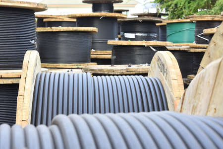 Wooden Coils Of Electric Cable Outdoor. High and low voltage cables in the storage.の写真素材