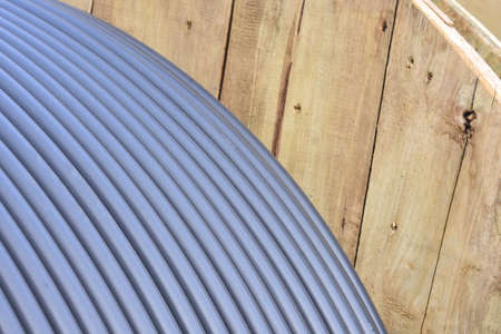 Wooden Coils Of Electric Cable Outdoor. High and low voltage cables in the storage.の写真素材
