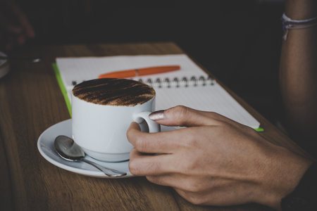 Woman holding cup of coffeeの写真素材