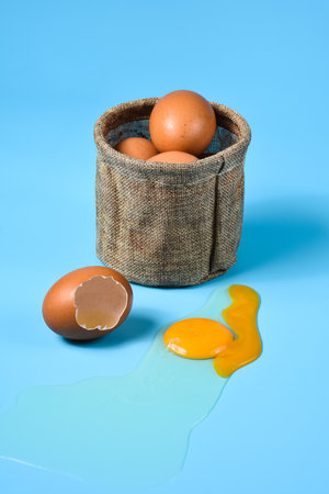 Fresh eggs in a sack bag on blue background.の写真素材