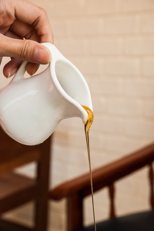 Pouring honey syrup の写真素材