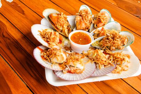 Seared scallops and mussels with spicy seafood sauce の写真素材