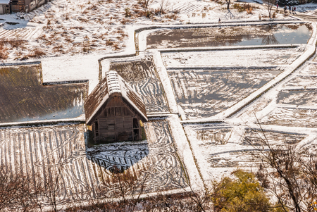 Top view of Shirakawa-go village with snow covering and autumn leaves foreground(Beginning of winter season)のeditorial素材