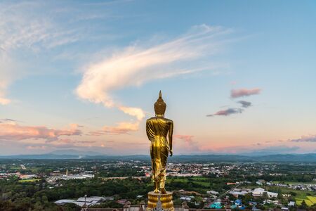 rear view of golden Buddha statue with city view background at  Phra That Khao Noi temple, Nan province, Thailandの写真素材