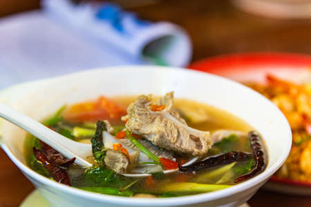 one of famous gourmet in Thailand. Pork rib spicy soup / pork bone with hot and sour soup bowl with...