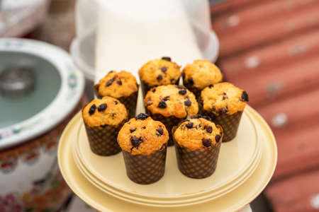 Homemade chocolate chip and raisin muffins in paper cup.の写真素材