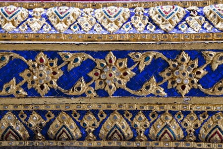 ancient ceramic tiles on the wall of wat phra kaew, bangkok, thailandの写真素材