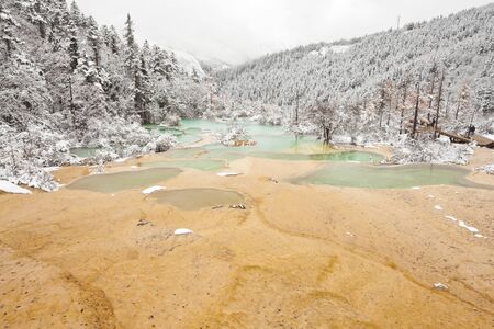 travertine beach and clear water at huanglong in late october, chinaの写真素材