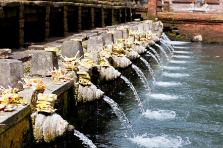 holy spring water in tirta empul, bali, indonesiaの写真素材
