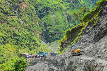 Govinghat, India - Aug 9 : The officer from Indian Highway Department clear the road that was blocking after landslide on August 9, 2014 in Govinghat, Indiaのeditorial素材