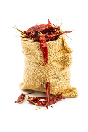 Dried chilli in a ramie sac on white backgroundの写真素材