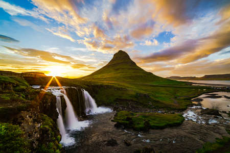 View of mount Kirkjufell and Kirkjufellfoss in Iceland at sunsetの写真素材