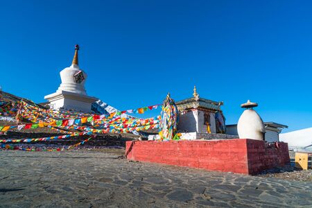 Stupa and prayer flags at the Zheduo Shan Pass, Kangding, Sichuan, Chinaの写真素材