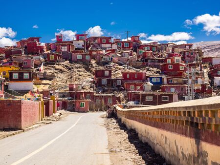Shacks of buddhist monks on the hill in Yarchen Gar Monastery in Sichuan, Chinaの写真素材